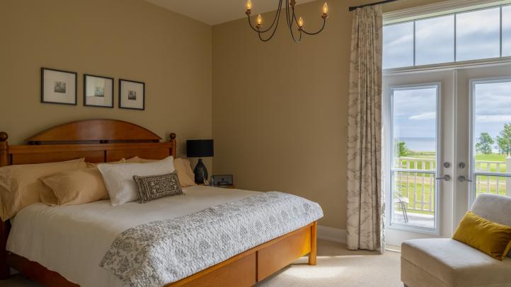 A picture of a guest room with a king size bed 